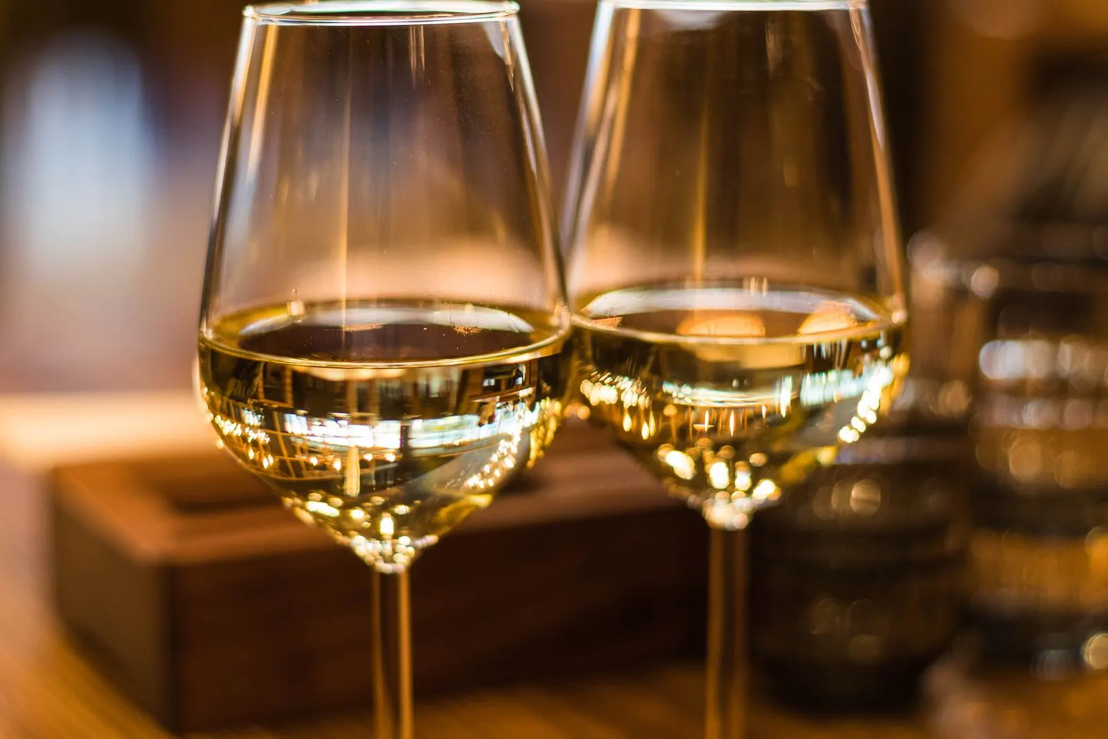 Deux verres de vin blanc sur une table.